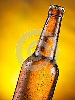 Cold bottle of beer with condensed moisture on it. photo