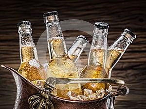 Cold bottles of beer in the brazen bucket.