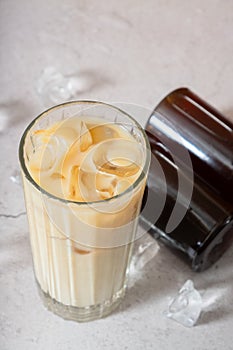 Cold brew coffee with milk and cold brew coffee in bottles with ice cube