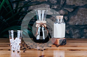 Cold brew iced coffee in glass and coffee beans.