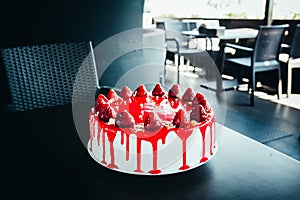 Cold cheesecake with strawberry and strawberry jell on table in restaurant