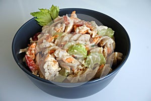 Cold chicken pasta salad in a grey bowl photo