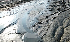 Cold clayey mud mixed with hydrocarbons, flows down from a mud volcano in the natural reserve of Salse of Nirano.