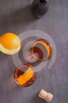 Cold cocktail Negroni Sbagliato with liqueur, vermouth and orange in glasses top and vertical photo