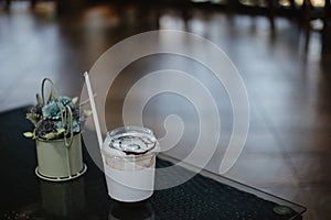 Cold cocoa glass on the glass table in cafe