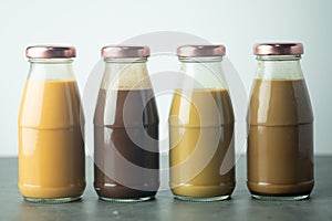 Cold coffee, cold Thai milk tea and cold cocoa in retro glass bottles