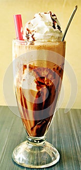 Cold coffee with ice cream in vertical frame