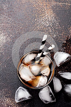 Cold Cola in glass with ice cubes