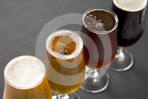 Cold craft beer assortment on a black background, low angle view. Close-up