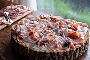 Cold cuts appetizer wooden chopping board tree trunk photo