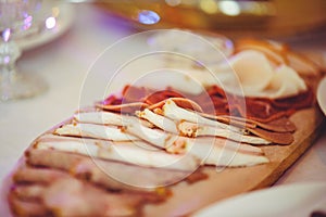 Cold cuts with ham, bacon, salami and bacon on a light background. Meat platter