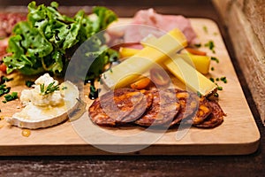 Cold cuts: Salami, Chorizo, Pepperoni and meats served with cheese, vegetable salad, red wine and cut toasts.