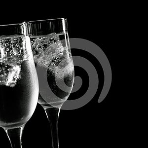 Cold drink in glasses with ice on a black background