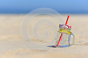 Cold drink in jar on the beachwith copy space.