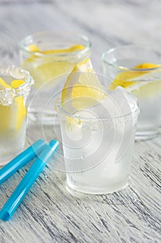 Cold drink with lemon and ice. Cool lemonade.