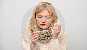 Cold and flu remedies. Take temperature and assess symptoms. High temperature concept. Woman feels badly ill sneezing