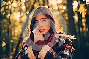 Cold flu season runny nose. Woman with allergy symptoms blowing nose. Portrait Of Young Woman Sniffing Nasal Spray