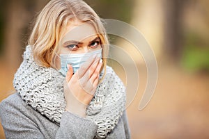 Cold and flu. Woman with a medical face mask at outdoor