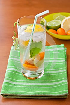 Cold fresh drink with lemon, lime, kumquat and mint.