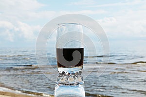 Cold frothy drink in the heat on the beach