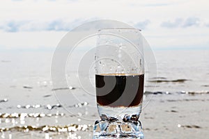 Cold frothy drink in the heat on the beach