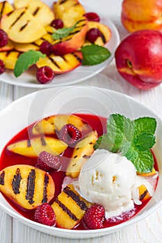 Cold fruit soup with raspberry, grilled nectarines, ice cream, vertical