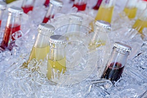 Cold glass beverages in heap of ice photo