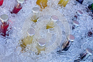 Cold glass beverages in heap of ice photo