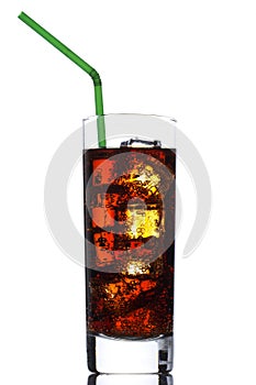 Cola being poured in a glass with ice cubes isolated on white background