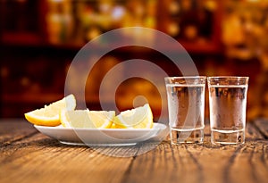 Cold glasses of vodka with slices of lemon