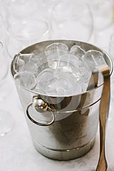 Cold ice in a bucket. Ice Bucket with tranparent cubes of ice