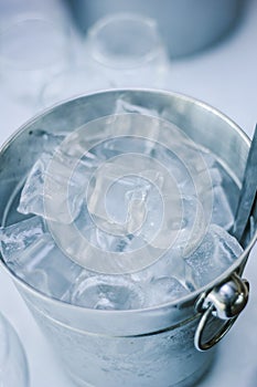 Cold ice in a bucket. Ice Bucket with tranparent cubes of ice