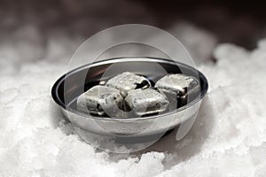 Cold ice cubes on red background