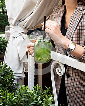 Cold kiwi lemonade and lime. Mug in the form of a jar. Drink with ice, green color