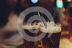 Cold light beer glass mug in a pub.