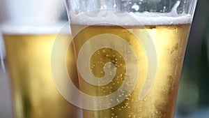 Cold light beer in a glass with water drops. beer bubbles, slow motion