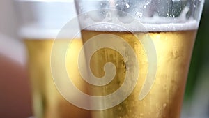 Cold light beer in a glass with water drops. beer bubbles, slow motion