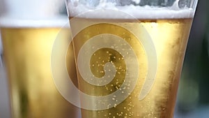 Cold light beer in a glass with water drops. beer bubbles, slow motion