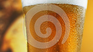 Cold Light Beer in a glass with water drops. Craft Beer close up. Rotation 360 degrees