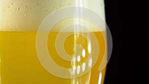 Cold Light Beer in a glass with water drops. Craft Beer close up. Rotation 360 degrees. 4K UHD video 3840x2160.There are