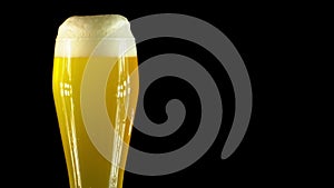 Cold Light Beer in a glass with water drops. Craft Beer close up. Rotation 360 degrees. 4K UHD video 3840x2160.There are