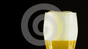 Cold Light Beer in a glass with water drops. Craft Beer close up. Rotation 360 degrees. 4K UHD video 3840x2160.There are