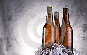 Cold light beer with water drops, beer bottles with ice cubes