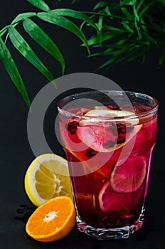 Cold limonade with garnet seeds and slices of lemon