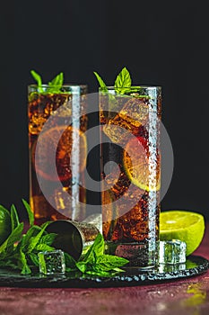 Cold Longdrink Cuba Libre in highball glass with water drops