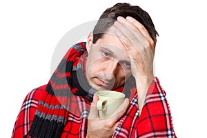 Cold man with flu, holding a mug