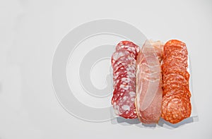 Cold meat plate. Appetizer with ham, prosciutto, salami on a white background. View from above