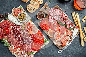 Cold meat plate Italian snacks food with ham, prosciutto, salami, pork chops, sausage and grissini bread sticks, catering banner,