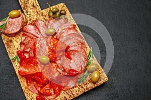 Cold meat plate with salami and chorizo sausage on cork wood board