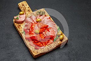 Cold meat plate with salami and chorizo sausage on cork wood board